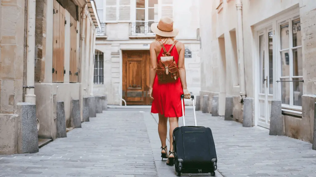 women in Europe with roller suitcase
